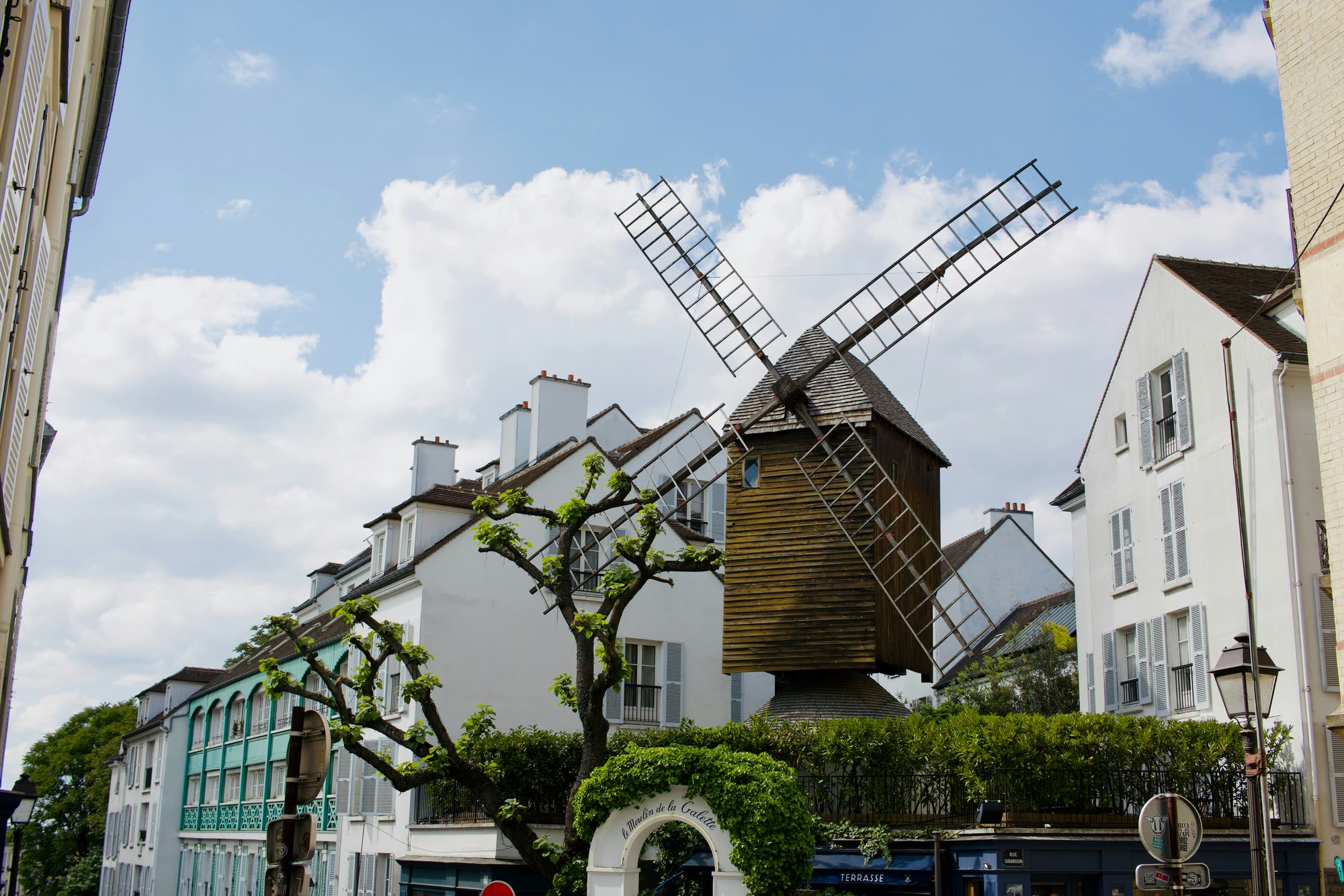 The Moulin de la Galette windmill rising above the white houses of rue Girardon